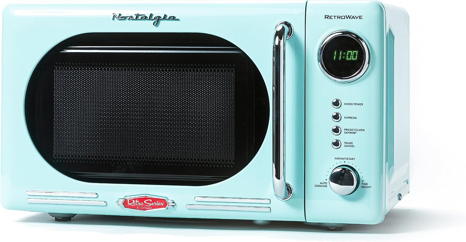 Retro-style Nostalgia microwave in pastel blue with chrome handle, digital display showing “11:00,” and labeled buttons including Micro Power, Express, Defrost, Pause, and a multifunctional dial for auto cooking and timer settings.
